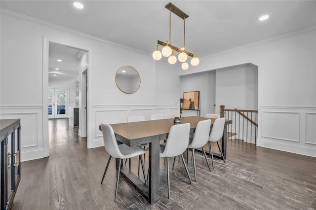 dining room with crown molding, a decorative wall, wood finished floors, and recessed lighting