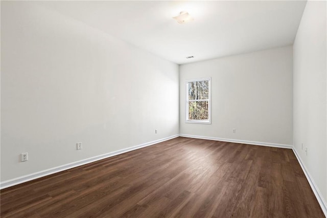 spare room featuring dark hardwood / wood-style floors