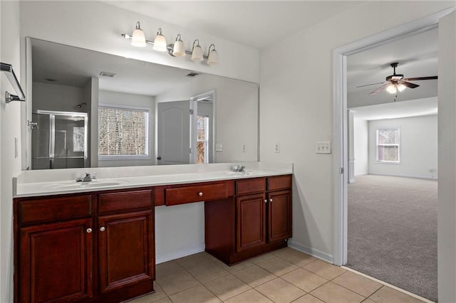 bathroom with an enclosed shower, tile patterned flooring, ceiling fan, and vanity