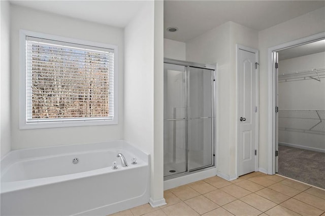 bathroom featuring tile patterned flooring and separate shower and tub