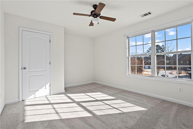 unfurnished room with ceiling fan and light colored carpet