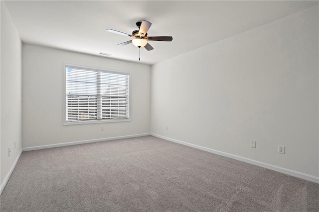 spare room featuring ceiling fan and light carpet