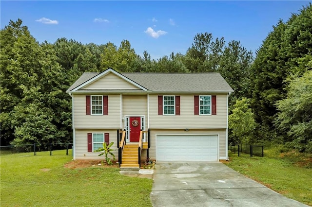 raised ranch with a front lawn and a garage