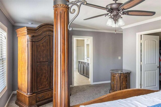 unfurnished bedroom with ensuite bathroom, light carpet, ornamental molding, and ceiling fan