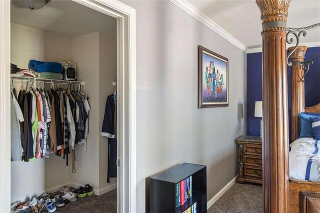 spacious closet with carpet flooring and ornate columns