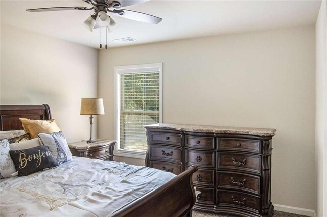 bedroom featuring multiple windows and ceiling fan