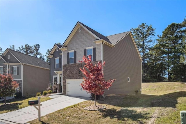 view of front of home featuring a front lawn and a garage