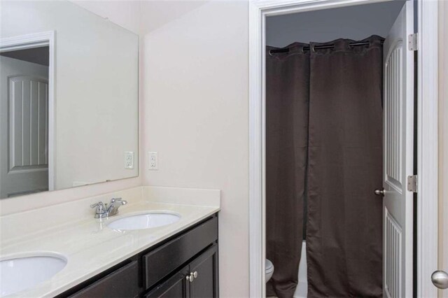 bathroom with vanity, a shower with curtain, and toilet