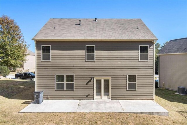 back of house with a patio, a yard, and central air condition unit