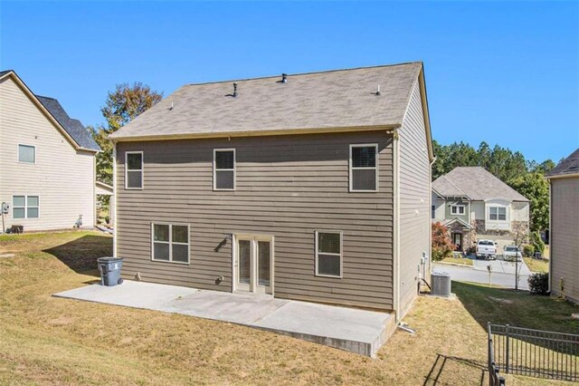 rear view of property with a patio, central AC unit, and a lawn