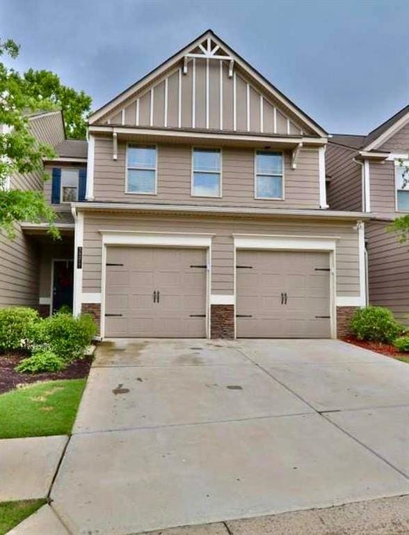 3277 Castleberry Village Dr, Cumming, GA 30040 - craftsman house with board and batten siding, a garage, concrete driveway, and stone siding