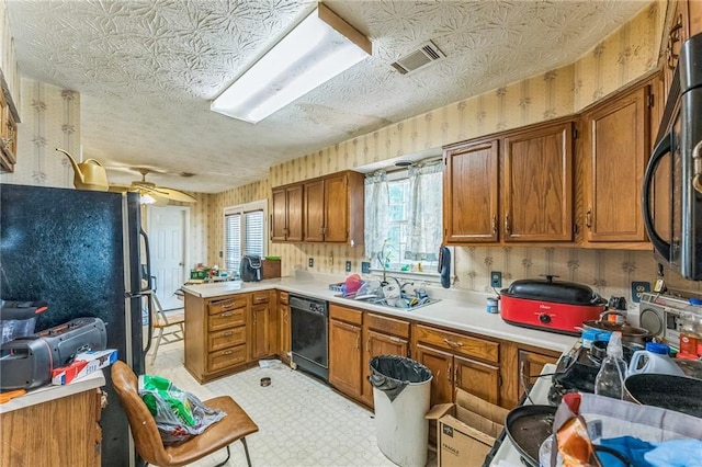 4945 Penscot Way, Stone Mountain, GA 30088 - kitchen featuring black appliances, brown cabinetry, a peninsula, light floors, and wallpapered walls