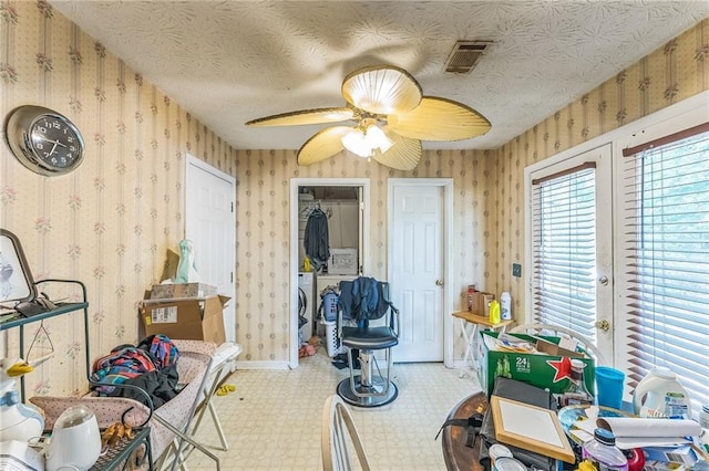 4945 Penscot Way, Stone Mountain, GA 30088 - dining space with tile patterned floors, a ceiling fan, wallpapered walls, and washer and dryer