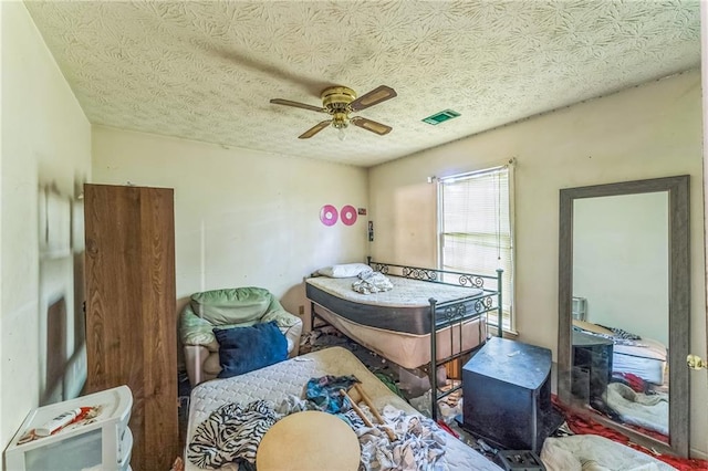 4945 Penscot Way, Stone Mountain, GA 30088 - bedroom featuring a textured ceiling and a ceiling fan