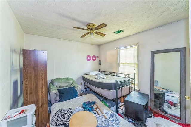 4945 Penscot Way, Stone Mountain, GA 30088 - bedroom with a textured ceiling and a ceiling fan