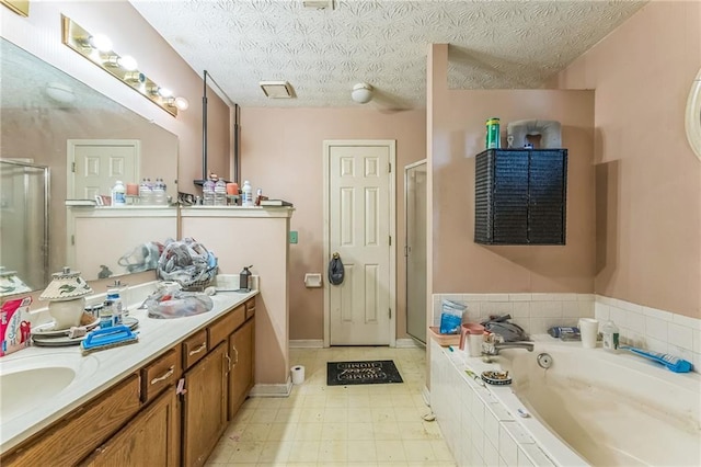 4945 Penscot Way, Stone Mountain, GA 30088 - full bathroom featuring a stall shower, a bath, double vanity, a textured ceiling, and baseboards