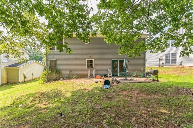 4945 Penscot Way, Stone Mountain, GA 30088 - back of house with a patio area and a lawn