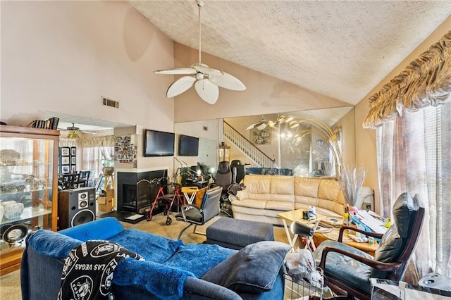 4945 Penscot Way, Stone Mountain, GA 30088 - living area with ceiling fan, a textured ceiling, carpet, a fireplace with raised hearth, and high vaulted ceiling