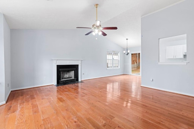 unfurnished living room featuring baseboards, a fireplace with flush hearth, vaulted ceiling, ceiling fan with notable chandelier, and light wood-style flooring