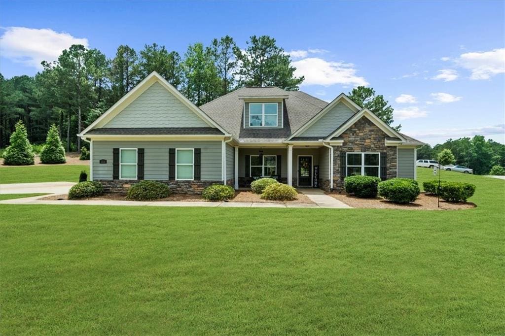 1212 Chapman Grove Ln, Monroe, GA 30656 - craftsman house featuring stone siding and a front yard