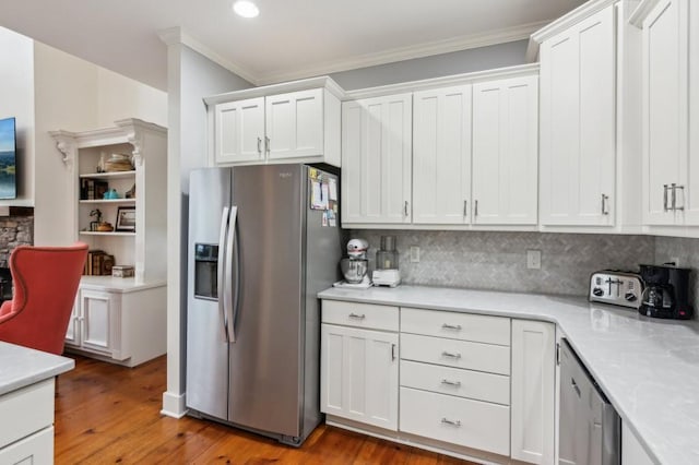 kitchen with stainless steel fridge with ice dispenser, crown molding, tasteful backsplash, light countertops, and white cabinets