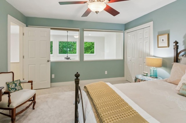 bedroom featuring a closet, ceiling fan, carpet floors, and baseboards