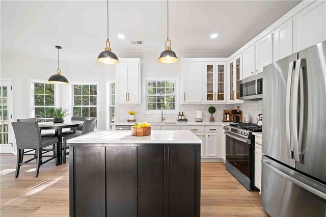 139 Thunder Ridge Ln, Acworth, GA 30101 - kitchen with stainless steel appliances, white cabinets, light countertops, backsplash, and recessed lighting