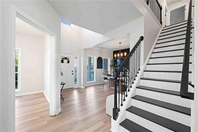 139 Thunder Ridge Ln, Acworth, GA 30101 - entrance foyer with stairs, a chandelier, healthy amount of natural light, and wood finished floors