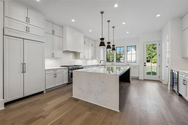 12632 Branyan Cir, Alpharetta, GA 30004 - kitchen featuring double oven range, wood finished floors, white cabinets, backsplash, and recessed lighting