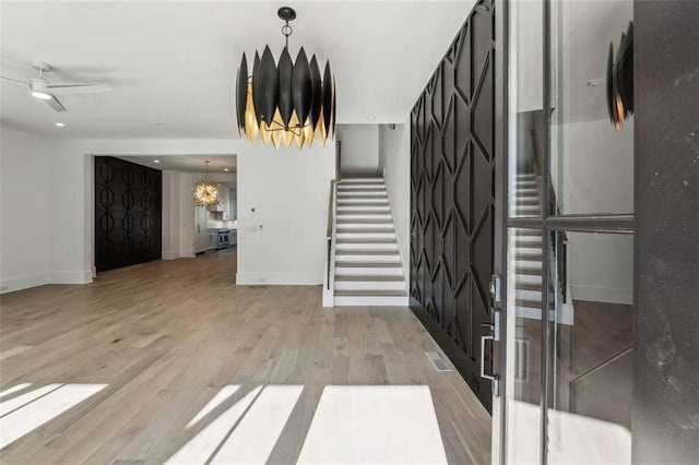 12632 Branyan Cir, Alpharetta, GA 30004 - foyer featuring stairway, light wood-style flooring, a chandelier, and ceiling fan