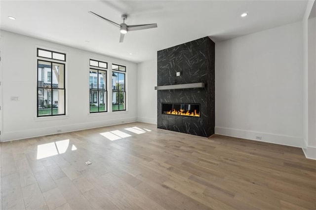 12632 Branyan Cir, Alpharetta, GA 30004 - unfurnished living room featuring a ceiling fan, wood finished floors, recessed lighting, and a high end fireplace