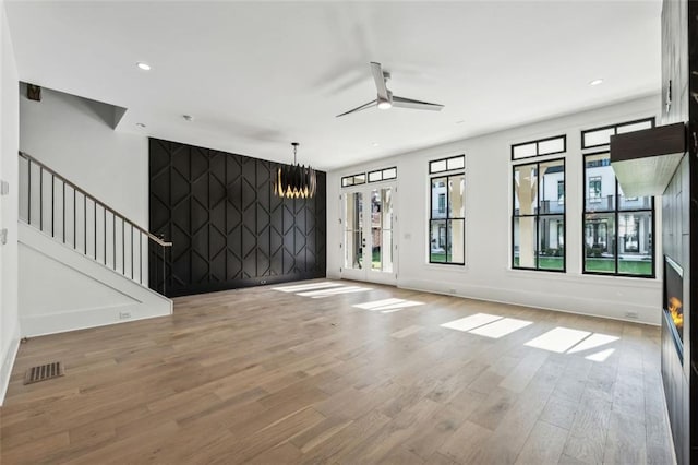 12632 Branyan Cir, Alpharetta, GA 30004 - unfurnished living room featuring wood finished floors, ceiling fan, stairway, a chandelier, and recessed lighting