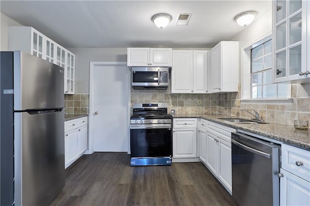 kitchen featuring stone counters, sink, appliances with stainless steel finishes, and white cabinets