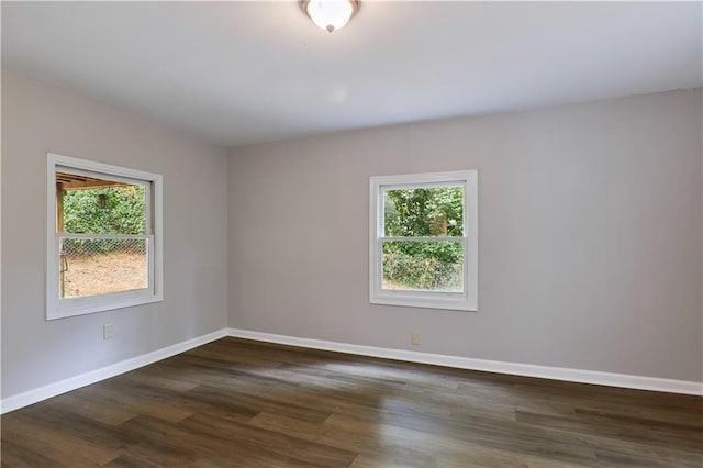 unfurnished room featuring dark hardwood / wood-style floors