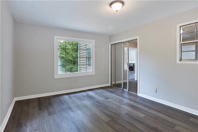 spare room featuring dark wood-type flooring