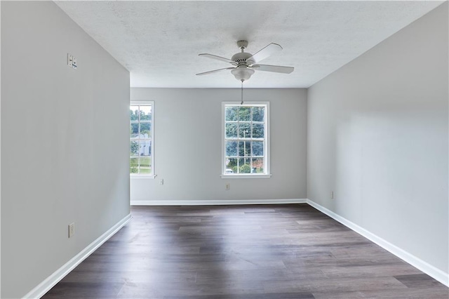 spare room with ceiling fan, dark hardwood / wood-style flooring, and a textured ceiling