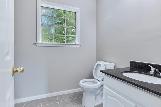 bathroom featuring vanity, toilet, and tile patterned flooring