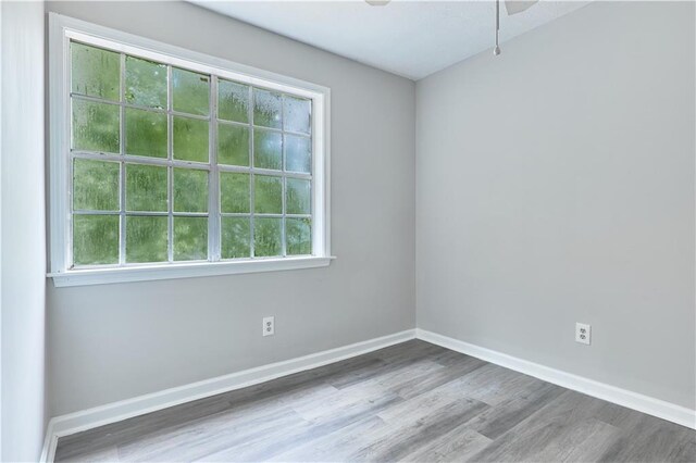 empty room with hardwood / wood-style flooring and ceiling fan