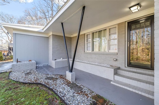 doorway to property with brick siding