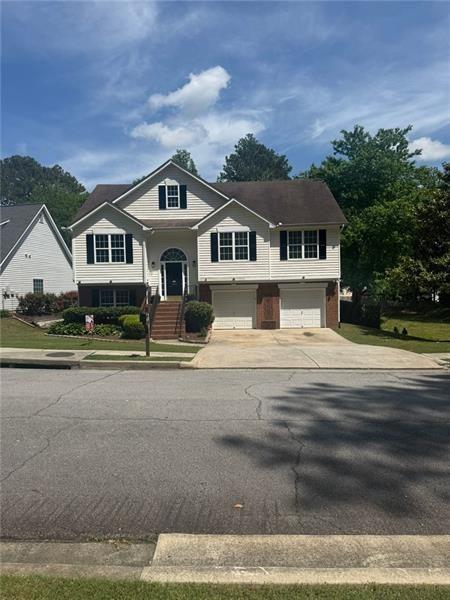 955 Tributary Way, Dacula, GA 30019 - raised ranch with a garage and driveway