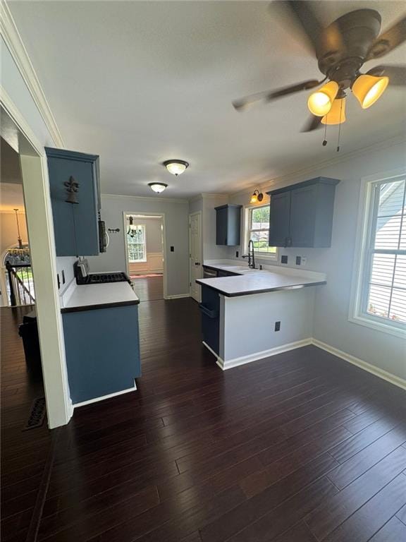 955 Tributary Way, Dacula, GA 30019 - kitchen featuring a peninsula, ornamental molding, light countertops, dark wood-type flooring, and a ceiling fan