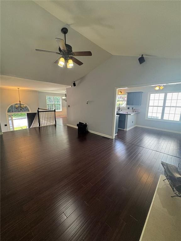 955 Tributary Way, Dacula, GA 30019 - unfurnished living room featuring lofted ceiling, a ceiling fan, and wood finished floors