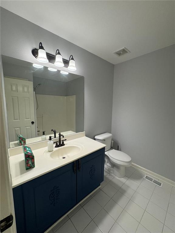 955 Tributary Way, Dacula, GA 30019 - bathroom with vanity, a shower, and tile patterned flooring