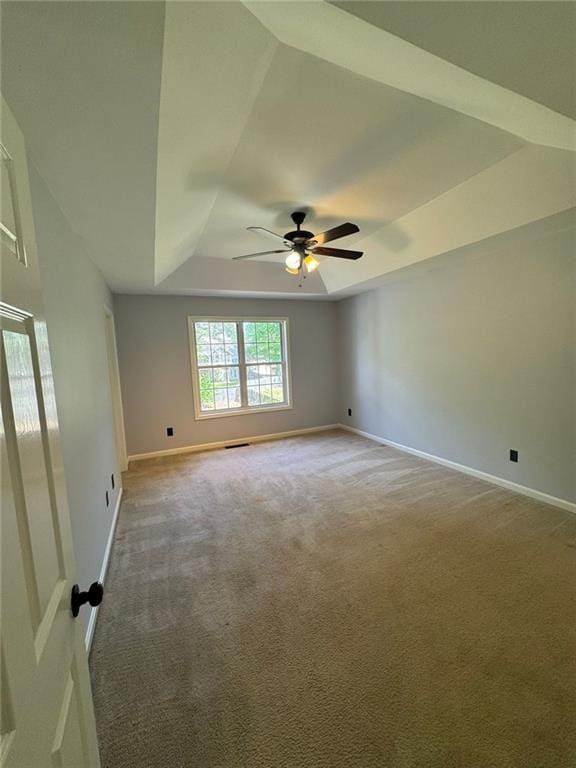 955 Tributary Way, Dacula, GA 30019 - spare room featuring a tray ceiling, light carpet, and a ceiling fan