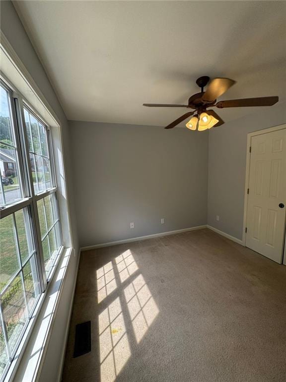 955 Tributary Way, Dacula, GA 30019 - spare room featuring healthy amount of natural light, light carpet, and ceiling fan