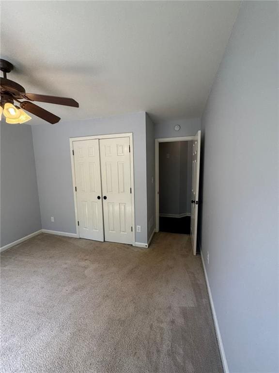 955 Tributary Way, Dacula, GA 30019 - unfurnished bedroom featuring a closet, carpet, and a ceiling fan