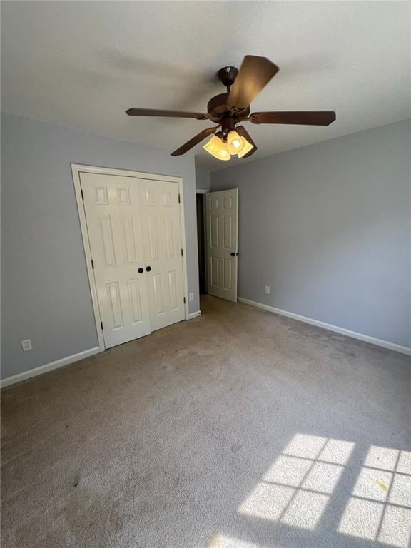 955 Tributary Way, Dacula, GA 30019 - unfurnished bedroom with carpet flooring, a closet, and a ceiling fan