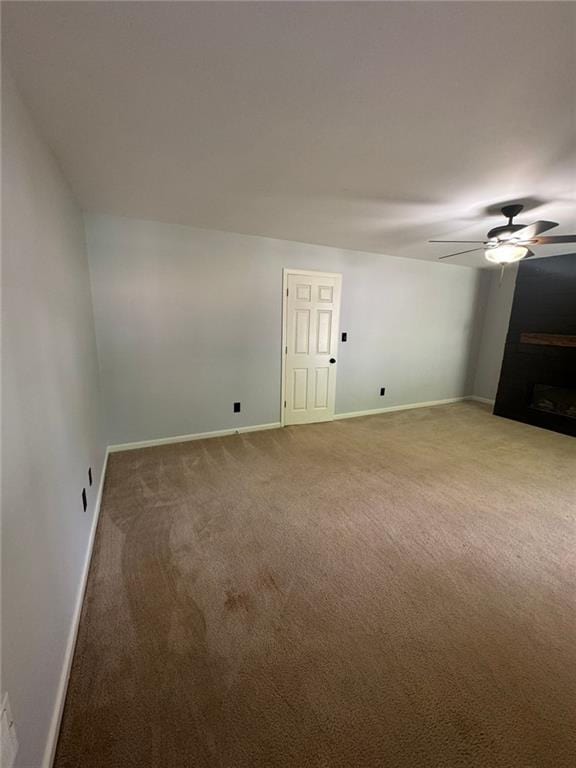 955 Tributary Way, Dacula, GA 30019 - spare room with a ceiling fan, light carpet, and a fireplace