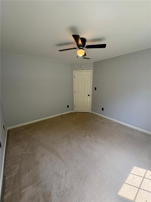 955 Tributary Way, Dacula, GA 30019 - carpeted empty room with ceiling fan and baseboards
