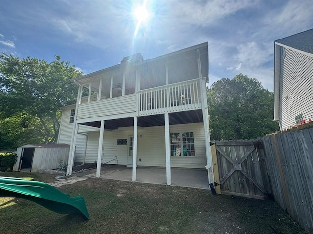 955 Tributary Way, Dacula, GA 30019 - back of property featuring a patio, a gate, a storage shed, a playground, and a balcony